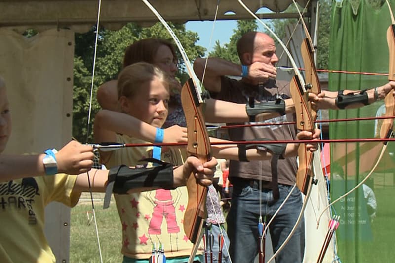 Children and Adults Participating in Archery