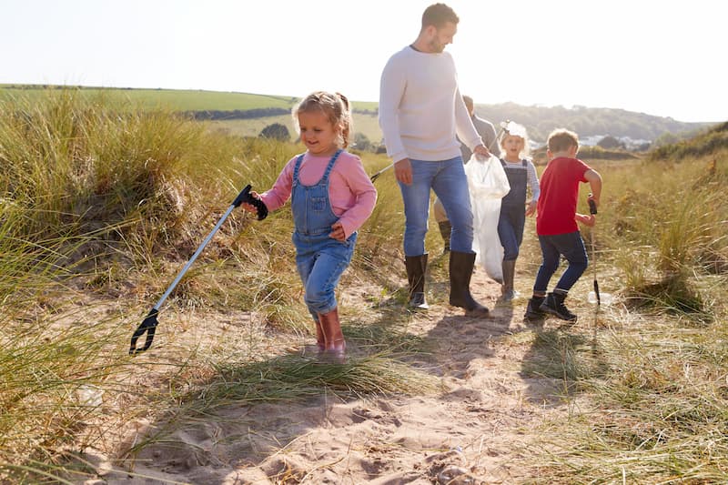 Father and Children Picking Up Trash